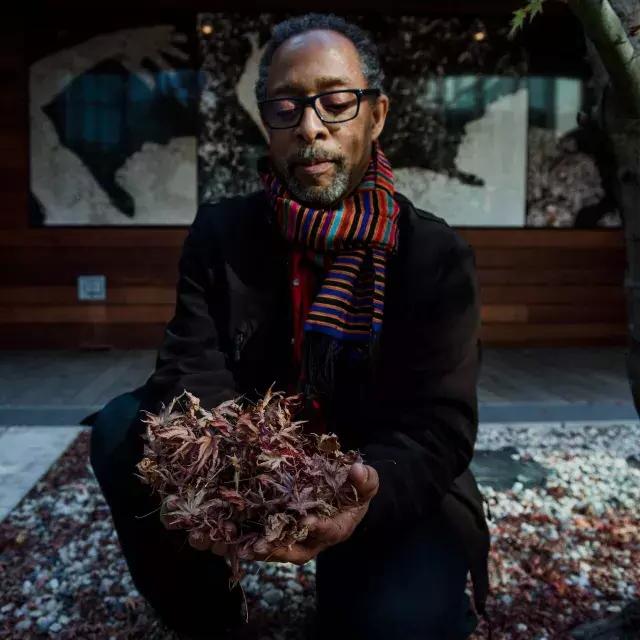 Ron Moultrie Saunders holding leaves.